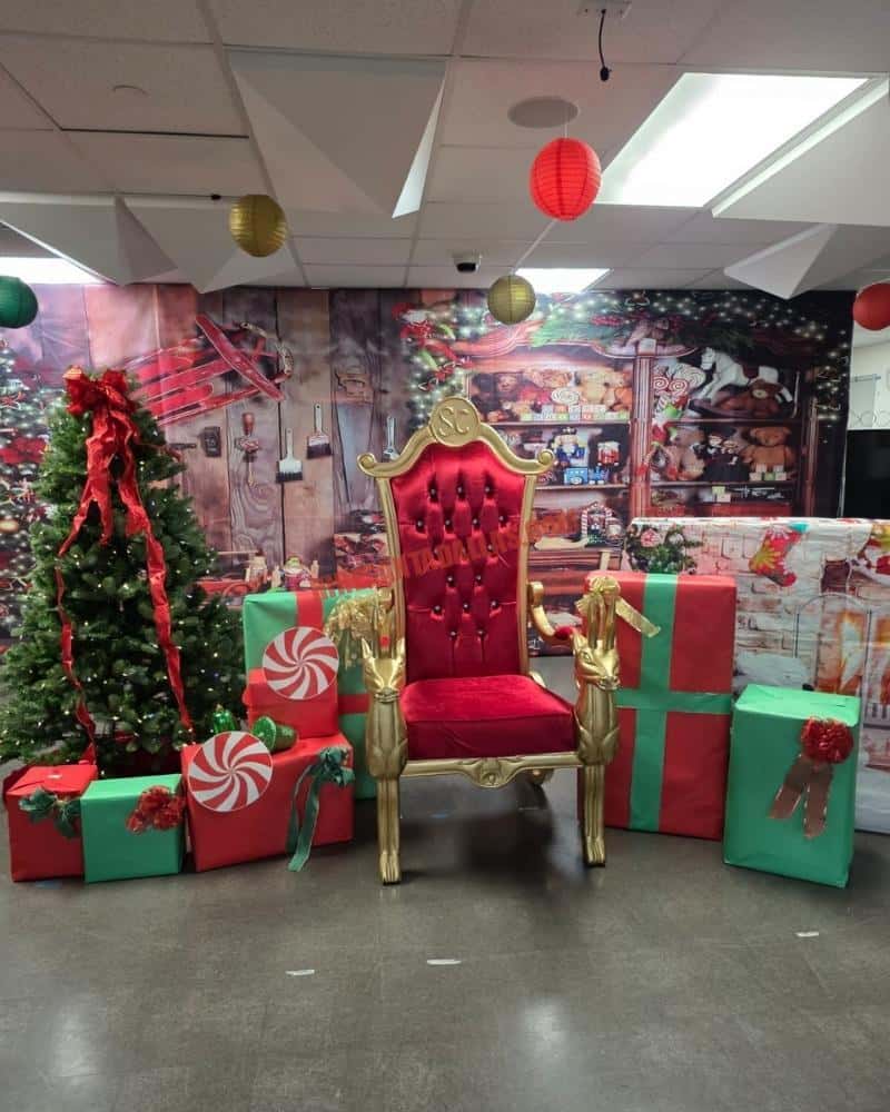 Santa chair photos: empty red tufted throne with gold reindeer arms, wrapped gifts, and a workshop backdrop.